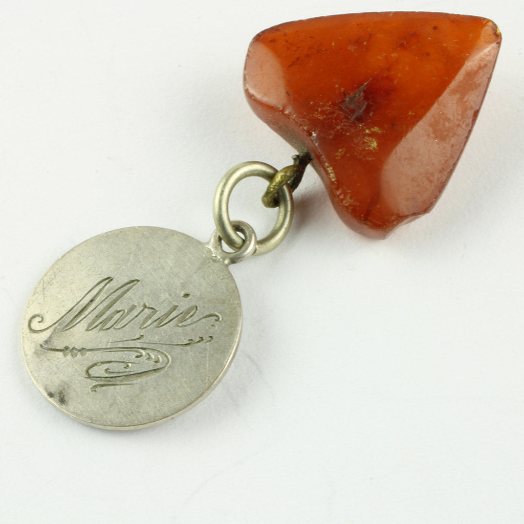 vedhæng hvor bagsiden er ned slebet og graveret med navnet Marie