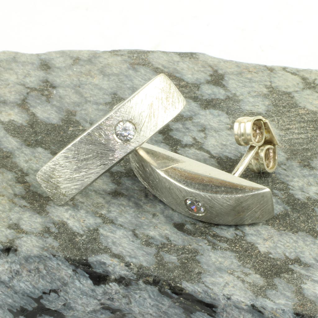 Ørestikker af sølv med isat sten