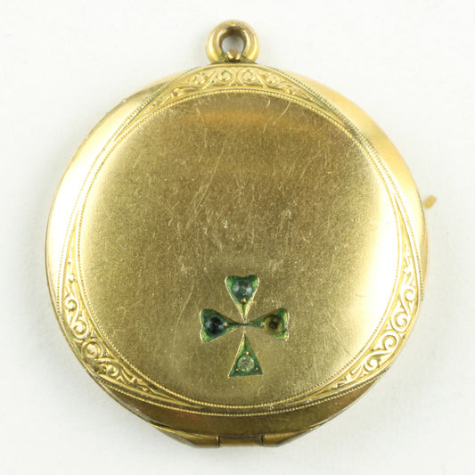 lille medaljon af forgyldt metal med forside med kantdekoration